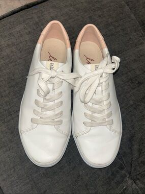 Ellen Degeneres blush and white leather sneakers.
